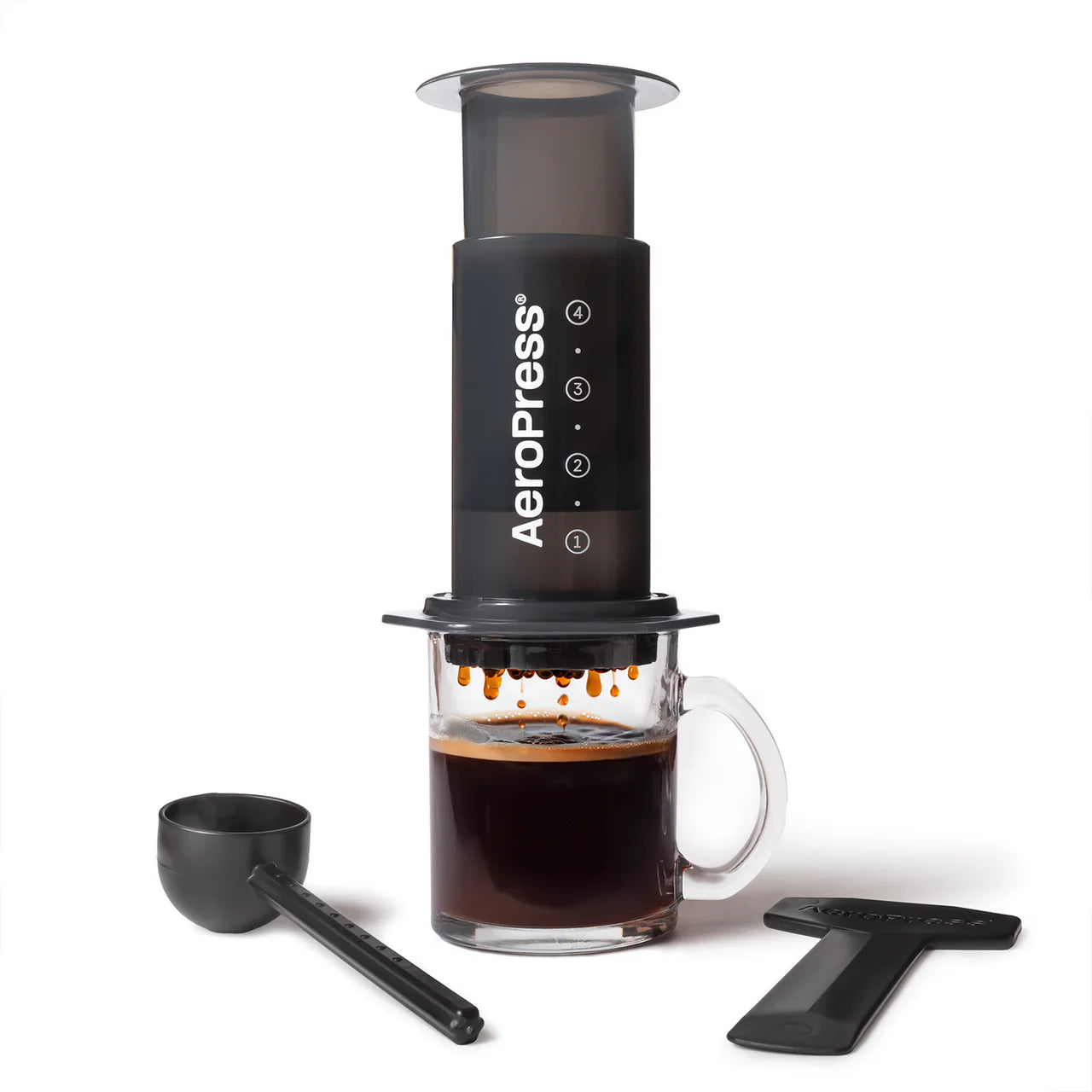 AeroPress Original coffee maker with a glass of brewed coffee. Scorgo Coffee & Roastery Co.