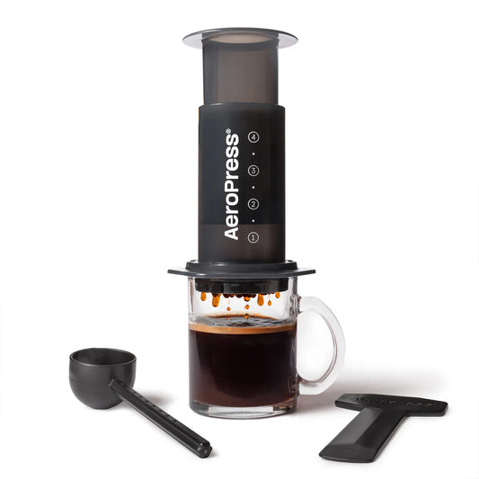 AeroPress Original coffee maker with a glass of brewed coffee. Scorgo Coffee & Roastery Co.